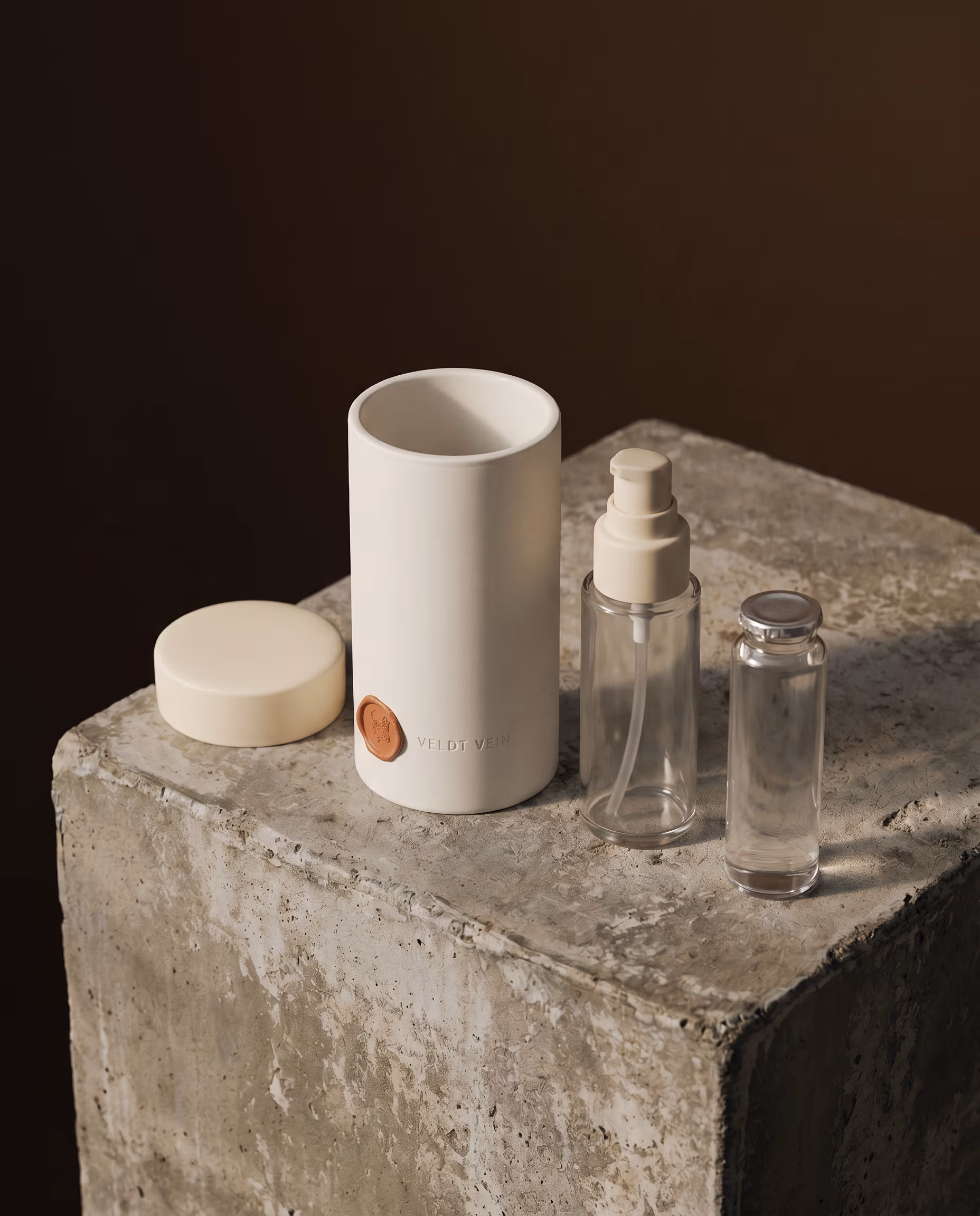 The Karoo Calm porcelain capsule disassembled — outer porcelain shell, inner refill vessel, and lid.